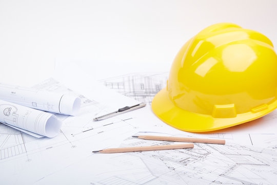 Yellow hard hat tools and drawings