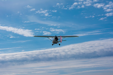 Fototapeta na wymiar Light engine plane soars above the clouds