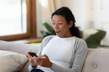 Surprised biracial woman shocked by good cell news