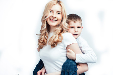 young modern blond curly mother with cute son together happy smiling family posing cheerful on white background, lifestyle people concept, sister and brother friends
