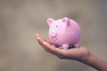 Indian little boy holding the piggy bank for his savings