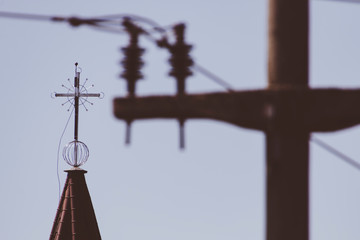 Obraz premium Church roof cross with faded power line in the background