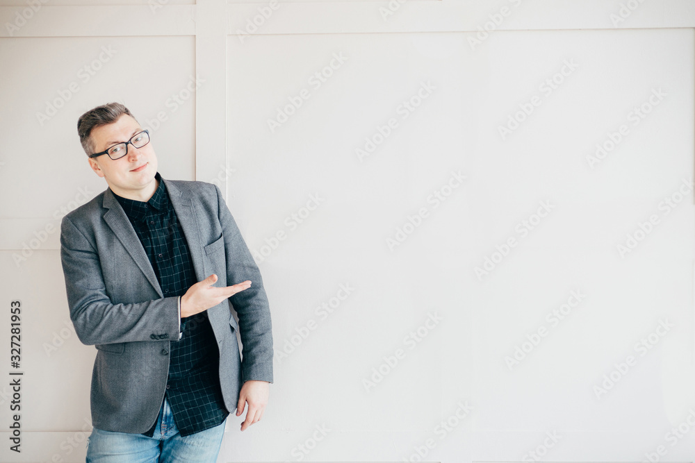 Wall mural successful businessman in modern office, pointing on copy space