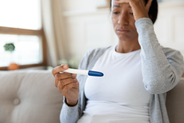 Unhappy biracial woman frustrated by negative pregnancy test result - Powered by Adobe