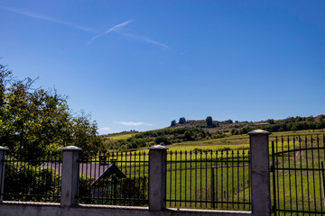 Large garden on a hill behind a fence