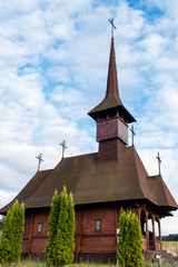 Fototapeta na wymiar Wooden church on a cloudy sky