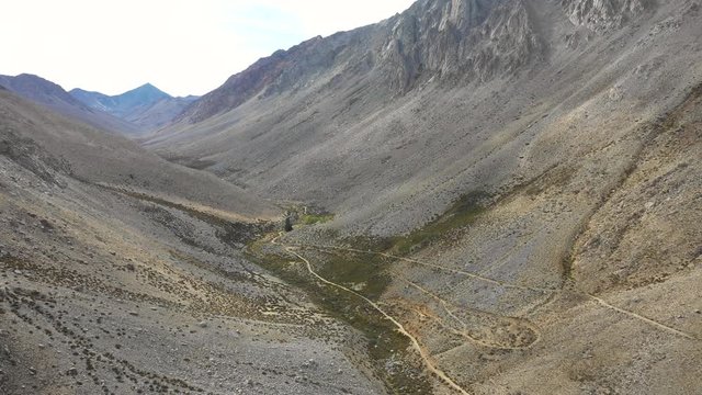 An aerial view inside Andes mountains at Limari Valley, south Atacama. An amazing wild scenery. Arid idyllic valleys with green farm fields feed in by the river at the bottom of the valley
