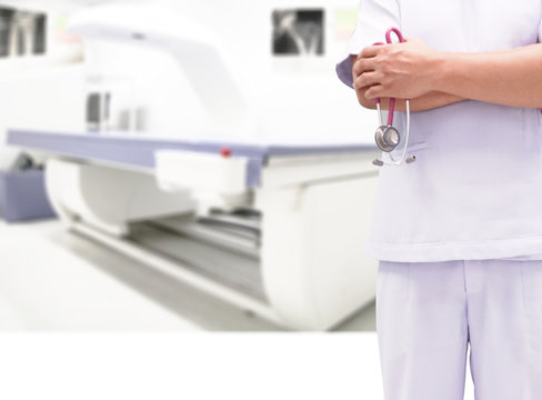Closeup doctor in white uniform gown coat hand holding stethoscope in clinic hospital and Bone densitometer in room.