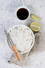 A bowl of cooked rice with chopsticks. Classic Japanese side dish