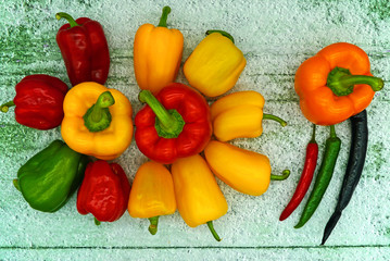 Colorful chilli peppers and paprika on the table