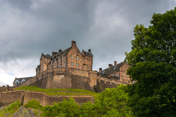 Fototapeta na wymiar Edinburgh Castle silhouetted against a cloud-laden sky. Concept: famous castles of Scotland
