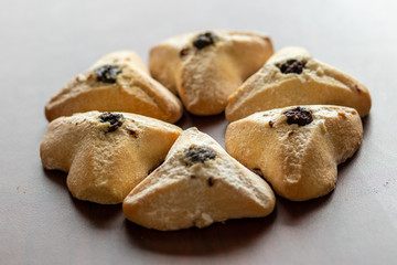 ozney haman (Haman Ear) Triangular pastry made of crispy dough stuffed. Traditional Jewish food for Purim. Located on a wooden surface