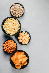 Set of appetizers and salty beer snacks. Pile of food for big company. Party, sport bar, pub, restaurant menu. Copy space