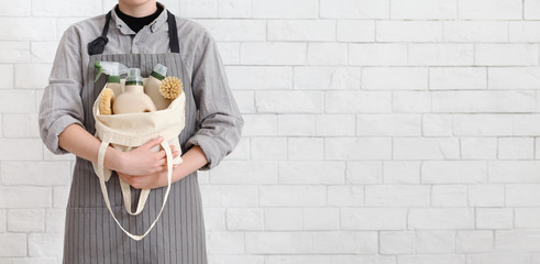 Young housewife choosing eco washing and cleaning detergents