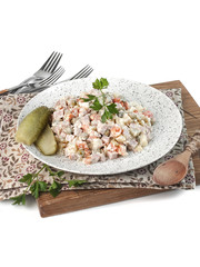 food photography of winter vegetable salad olivier with meat, pickled cucumbers with mayonnaise on a white background isolated close up