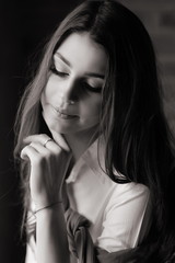 Portrait of a beautiful brunette girl in a white shirt