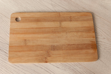 Empty wood cutting board on planks food background concept