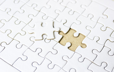 Fototapeta premium Fill the missing parts fragment of white jigsaw concept puzzle for succeed