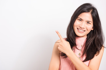 Portrait Asian beautiful young woman standing pointing finger up