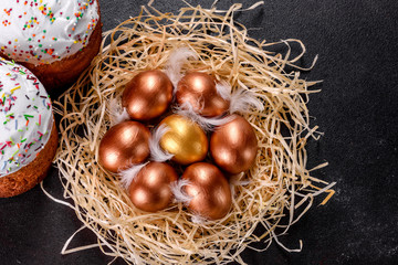Easter golden eggs in the nest, preparation for the holiday
