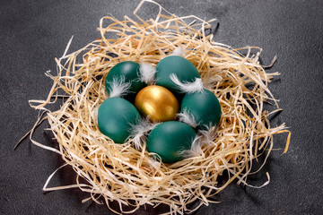 Easter golden eggs in the nest, preparation for the holiday