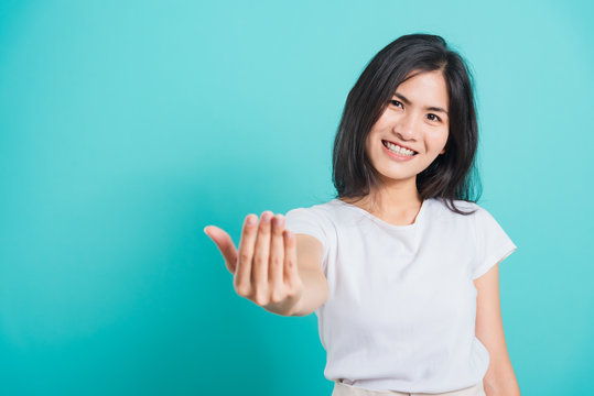 woman smile wear white t-shirt making gesture with hand inviting to come