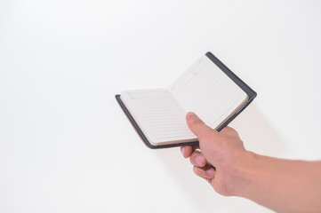 Holding a notebook on a white background