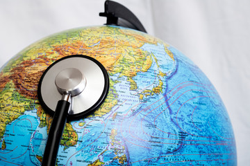 Stethoscope on a globe, planet disease concept