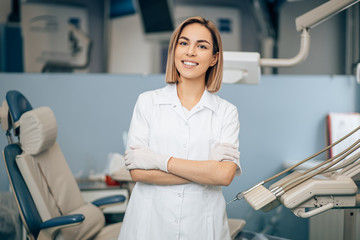 beautiful dentist woman at work place, doctor preparing to treat patient's teeth in dental office