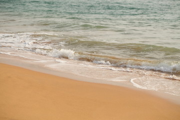 Fototapeta na wymiar foam on sandy tropical ocean beach