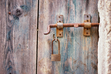 Padlocked on old wooden door.