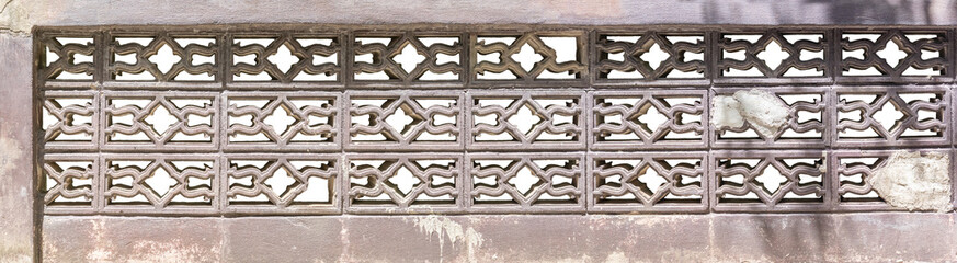 Long concrete block wall isolated on white background.