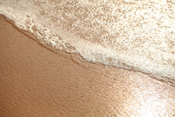 foam on sandy tropical ocean beach