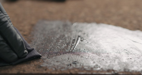 man hands applying oil finish on cork surface