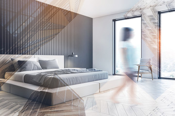 Woman walking in gray bedroom corner with armchair