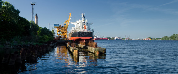 Obraz premium MARITIME TRANSPORT - Freighter at the transhipment terminal in a seaport