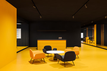 Black and yellow office reception with armchairs