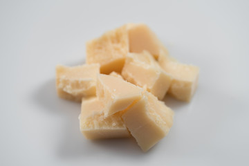 Parmesan cheese chunks on white background