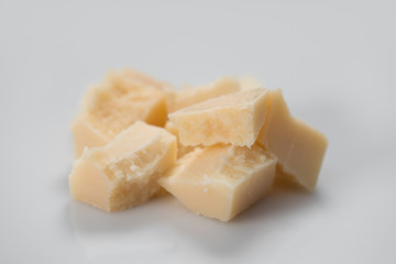 Parmesan cheese chunks on white background