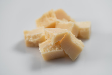 Parmesan cheese chunks on white background