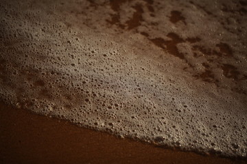 foam on sandy tropical ocean beach
