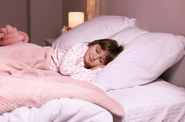 Fototapeta na wymiar Cute little girl sleeping in bed at night