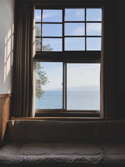 Fototapeta na wymiar Calm Interior, sofa seat for look seascape mountain landscape view from window in morning
