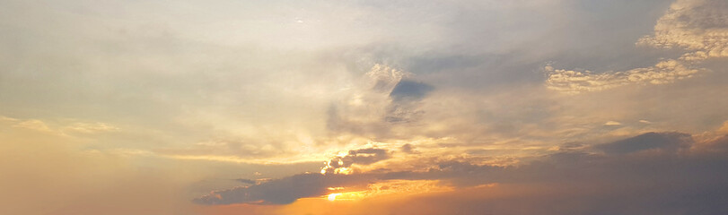 Sky clouds background. Beautiful sunset landscape with clouds and orange sun light on sky