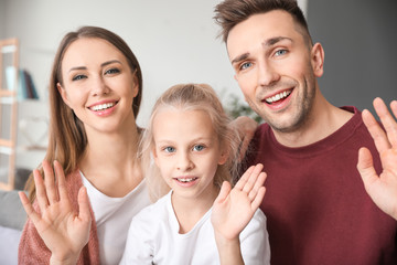 Fototapeta premium Portrait of family video chatting at home