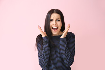 Stressed young woman on color background