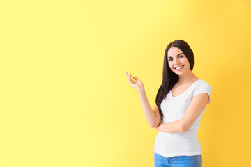 Beautiful young woman on color background