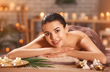 Beautiful young woman relaxing in spa salon