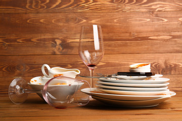 Dirty tableware on wooden background