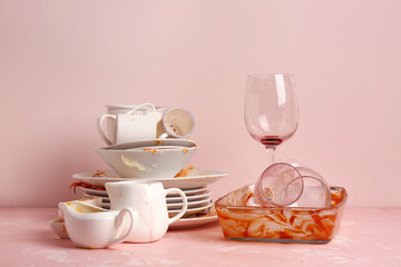 Dirty tableware on color background